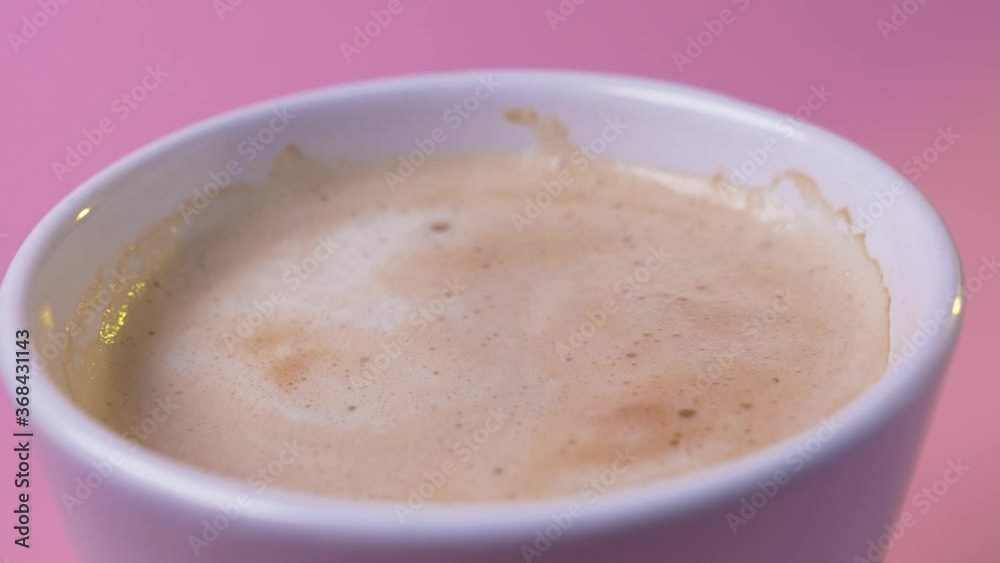 Close up hot brown cacao stands on pink background milk drink cup dessert chocolate food coffee delicious tasty fresh aroma slow motion Close up hot brown cacao stands on pink background milk drink cup dessert chocolate food coffee delicious tasty fresh aroma slow motion