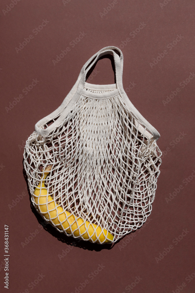 Fototapeta premium beige mesh zero waste bag pattern on a brown background