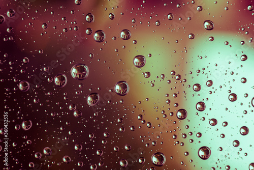 Drops of water on a window pane  raindrops on a window  abstract  colorful