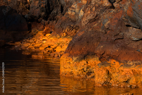 cliffs and rocks of santorini and nea kameni island photo