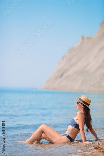 Young woman in hat on the beach vacation