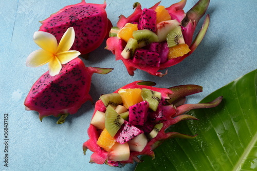 Fototapeta Naklejka Na Ścianę i Meble -  Dragon fruit (Pitaya, Pitahaya).Sliced pieces pitahaya fruit and fruit salad,and frangipani flowers.