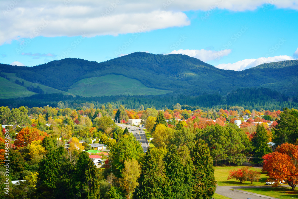 Bright and sunny autumn day in Turangi town with magnificent mountains of Tongariro National Park in the background. North Island Volcanic Plateau, New Zealand