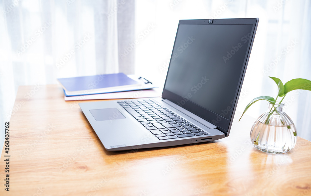 Laptop and folders on desk