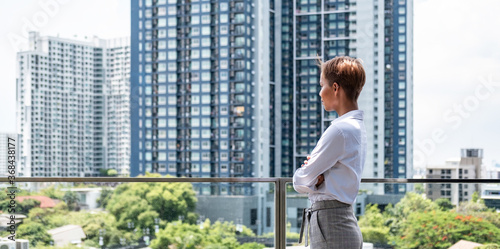 Successful business woman looking at city stock photo