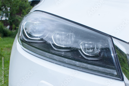 Closeup headlights of car. Car exterior detail.