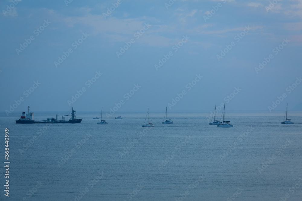 sunset with yachts on santorini island Greece