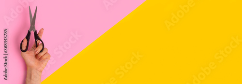 Scissors are in the woman's left hand. Banner in bright pink and yellow, split in half. International Left-handers Day on August 13.