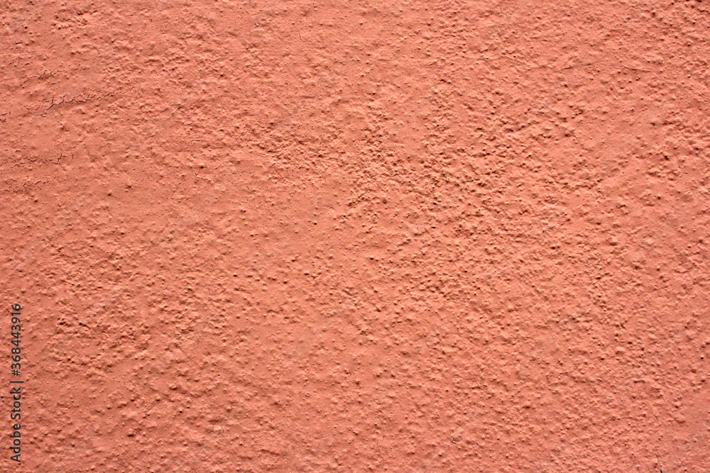 Peachy rough wall. Orange background. Peachy rough wall. Orange background.