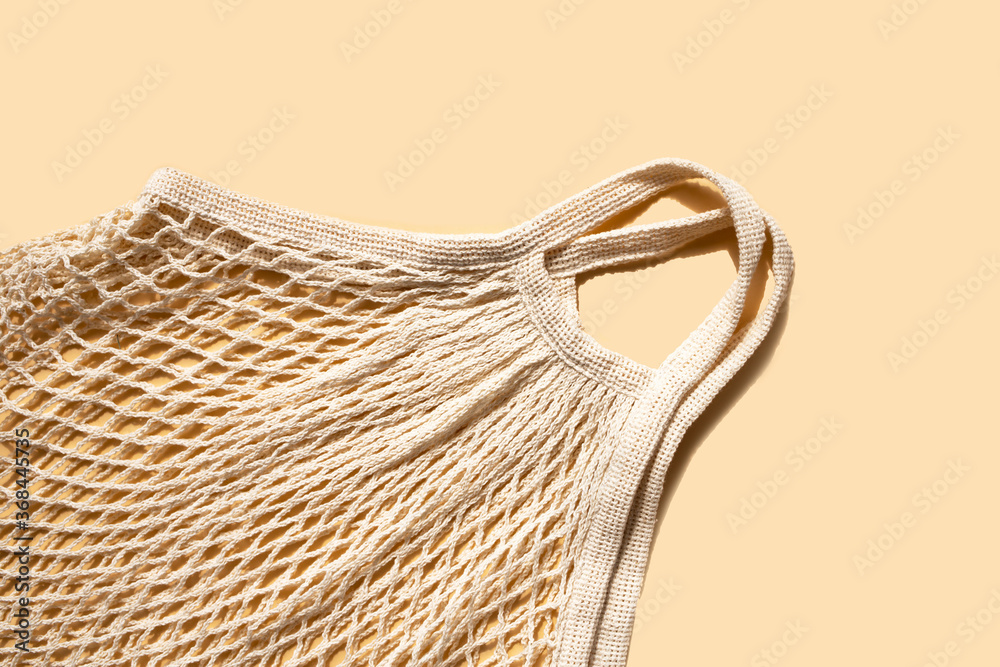 Obraz premium Natural mesh bag on a light background. Zero waste. Place for text. Flat lay.