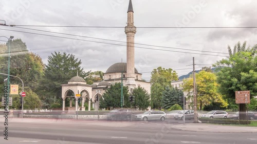 Ali Pasha Mosque timelapse hyperlapse with traffic on intersection, It was completed in 1561 after plans of Hadim Ali Pasha, Sarajevo, Bosnia and Herzegovina. photo