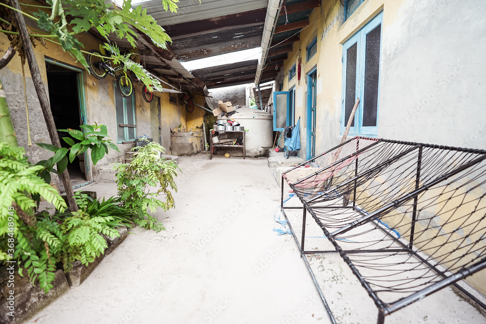 Traditional benches made of nets and pipes in house courtyard at Bodufolhudhoo island village