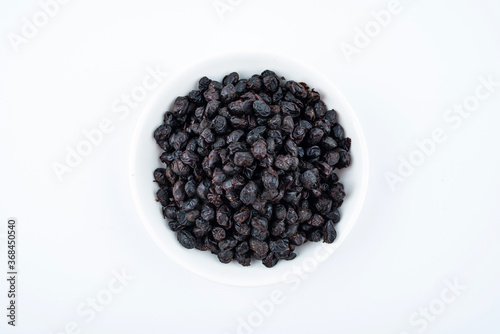 A saucer of black tempeh on white background