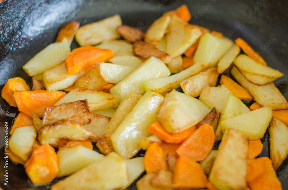 Delicious fried potatoes with carrots Delicious fried potatoes with carrots