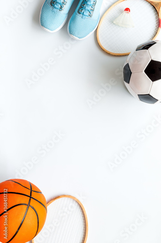 Flat lay of sport balls and rackets on white background. Above view  copy space
