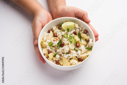 Tasty Sabudana khichadi / khichdi is an Indian dish made from soaked sago or tapioca pearls photo