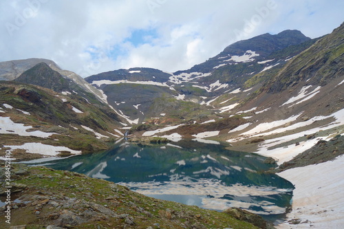 Mountain lake called Munia in Pyrenees mountains on a long-distance hiking trail GR11 in Spain