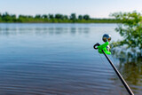 summer fishing on the river. fishing rod feeder, space for copying text. selective focus