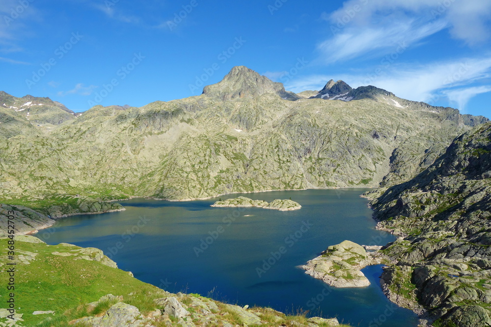 Mountain lake called Embalse Bachimana in Pyrenees on a hiking trail GR11/HRP in Spain