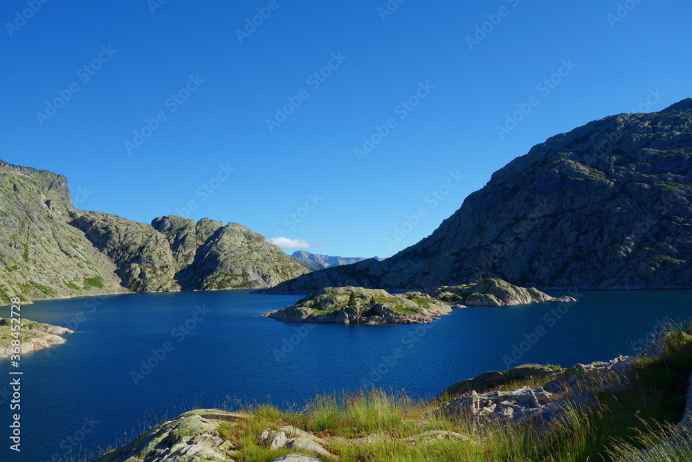 Mountain lake called Embalse Bachimana in Pyrenees on a hiking trail GR11/HRP in Spain