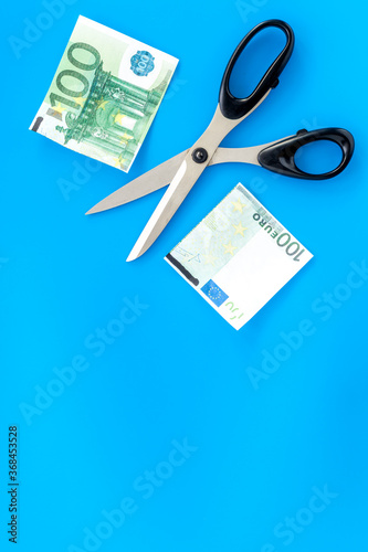 Decline of euro exchange rate. Scissors cut dollars banknote