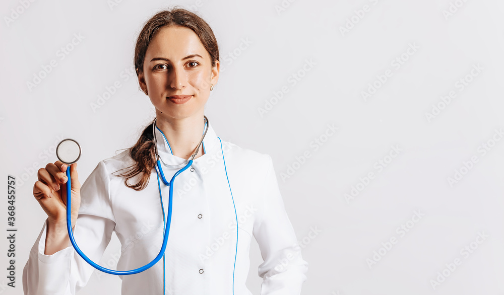 Doctor with a stethoscope in the hands on white background