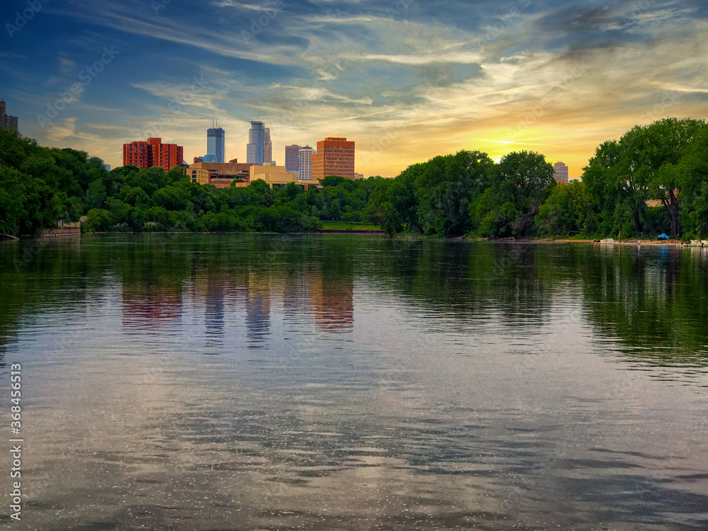 An agreeable sunset scene of the Minneapolis skyline taken near the University of Minnesota campus on the Mississippi river.