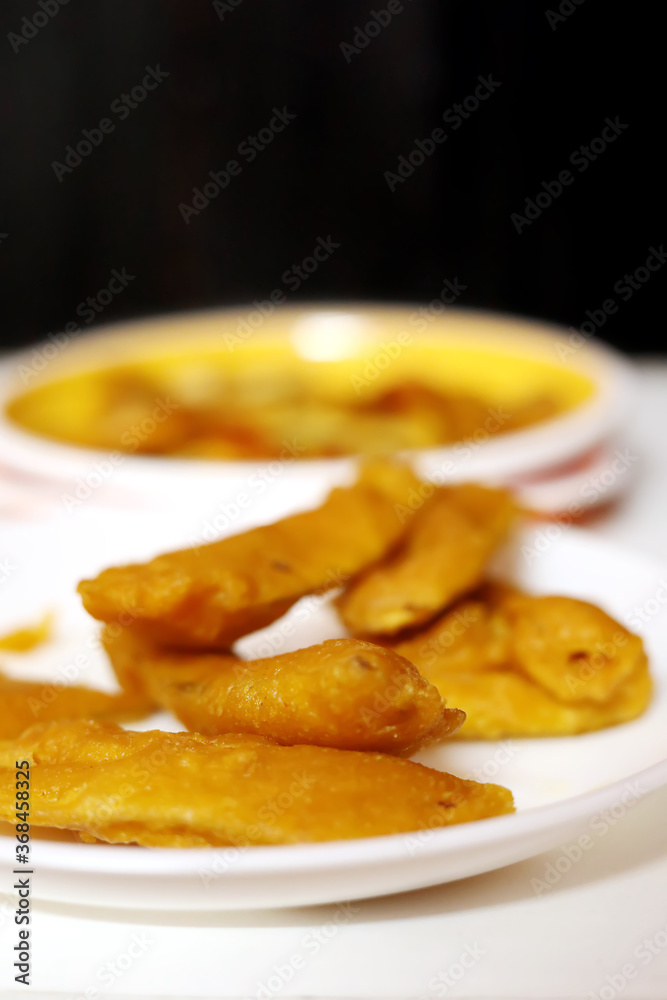South Indian Potato Snack, Vazhakkai Bajji served on black background South Indian Potato Snack, Vazhakkai Bajji served on black background