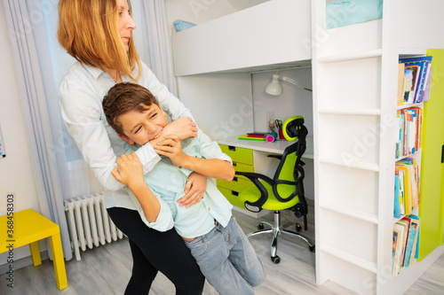 Tableau sur toile Close portrait of little autistic boy bite hands with strong negative face expre