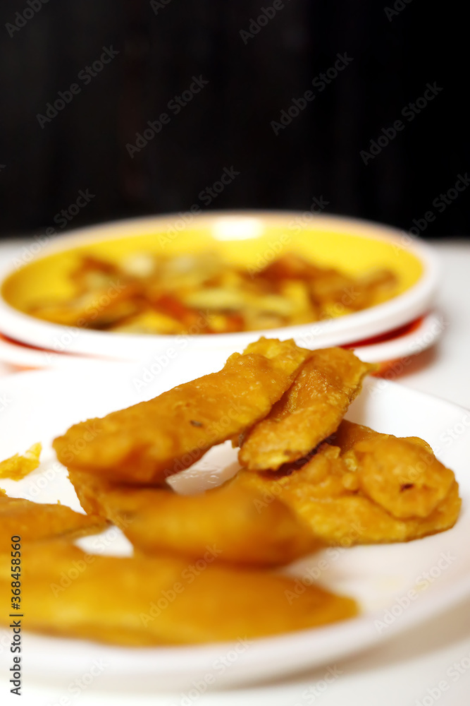 South Indian Potato Snack, Vazhakkai Bajji served on black background South Indian Potato Snack, Vazhakkai Bajji served on black background