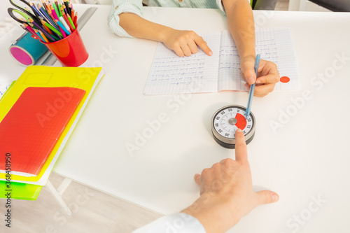 Teacher woman's hand point to the lesson timer during development class exercise