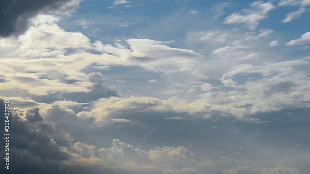 Timelapse of Cumulus cloud formation on a clear summer day close up. The sun's rays fall at an angle on the clouds Timelapse of Cumulus cloud formation on a clear summer day close up. The sun's rays fall at an angle on the clouds