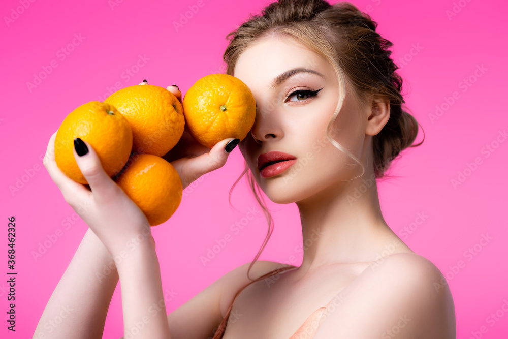 elegant beautiful blonde woman holding ripe oranges isolated on pink elegant beautiful blonde woman holding ripe oranges isolated on pink