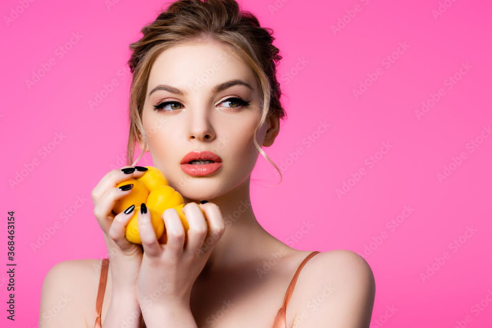 beautiful blonde woman holding ripe apricots isolated on pink beautiful blonde woman holding ripe apricots isolated on pink