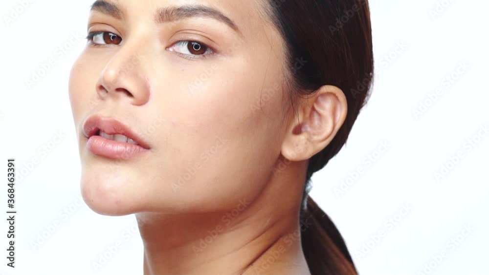 Closeup face of beautiful Asian woman looking at the camera over white background. Natural beauty. Skin care cosmetics Closeup face of beautiful Asian woman looking at the camera over white background. Natural beauty. Skin care cosmetics