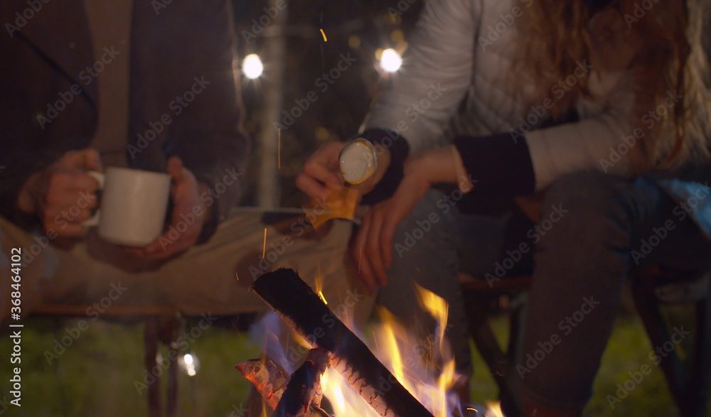 Young happy couple near the bonfire Young happy couple near the bonfire