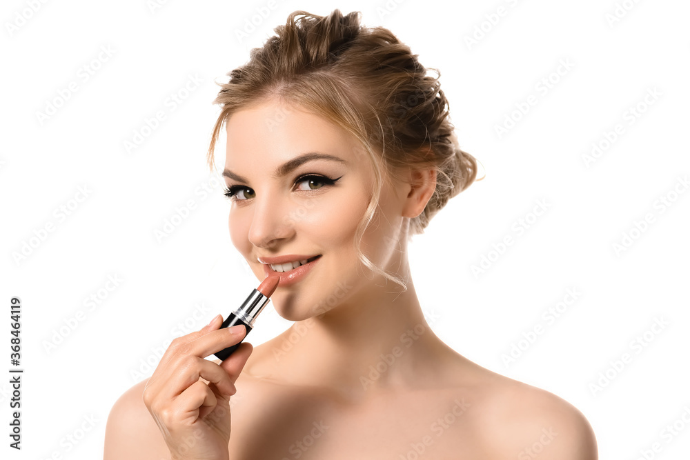 smiling naked beautiful blonde woman applying beige lipstick isolated on white smiling naked beautiful blonde woman applying beige lipstick isolated on white