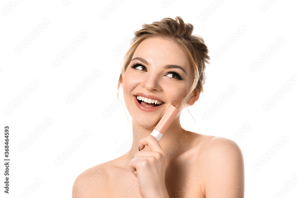 smiling naked beautiful blonde woman with makeup and black nails holding beige lip gloss isolated on white