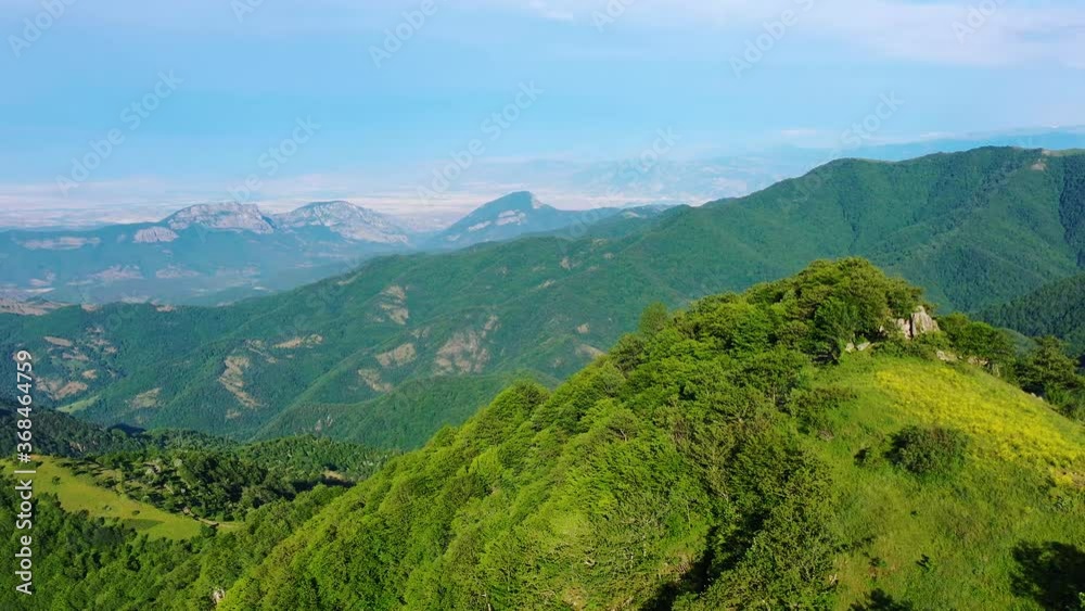 Aerial view mountains in Syuniq, Armenia. Aerial shot green mountains with blue sky background.Drone low fly over forest and show amazing view of green landscape. Aerial view mountains in Syuniq, Armenia. Aerial shot green mountains with blue sky background.Drone low fly over forest and show amazing view of green landscape.