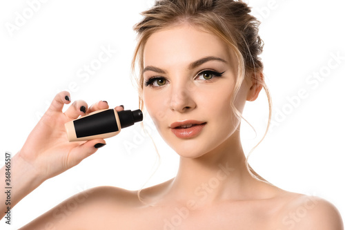 naked beautiful blonde woman with makeup and black nails holding face foundation isolated on white