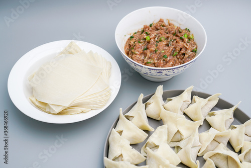 Traditional Chinese food wonton is placed on agray plate.