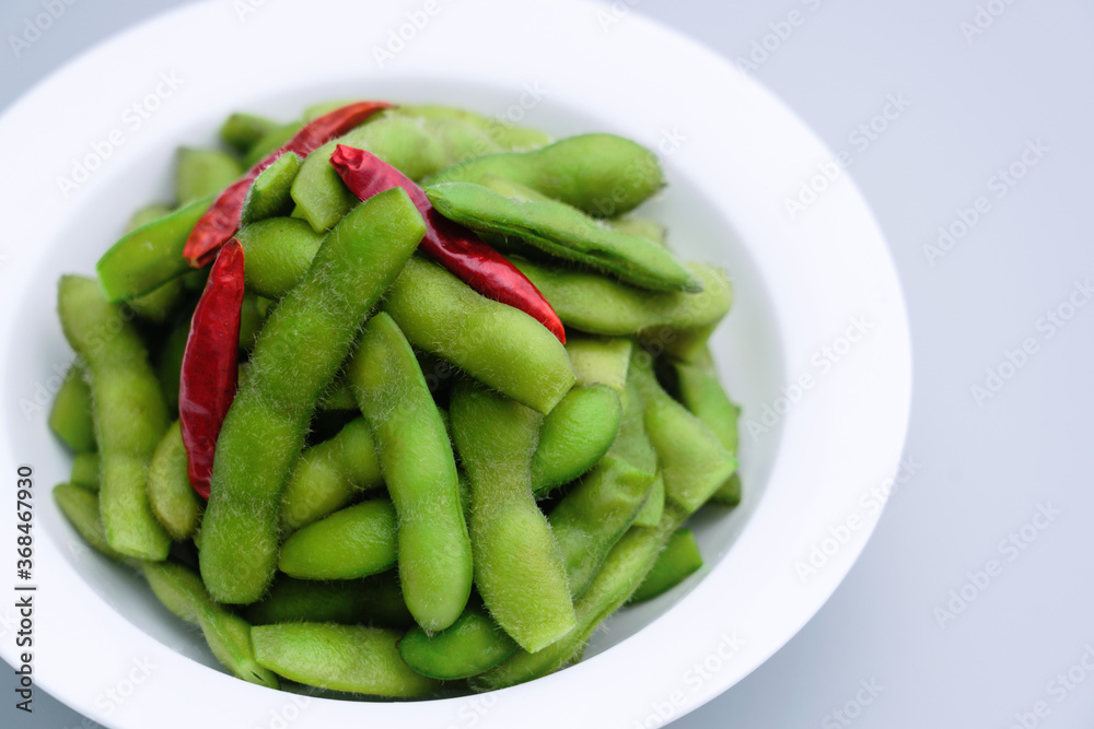 A traditional Chinese delicacy in solid color, boiled soybeans in brine. Chinese traditional food boiled soybean. A traditional Chinese delicacy in solid color, boiled soybeans in brine. Chinese traditional food boiled soybean.