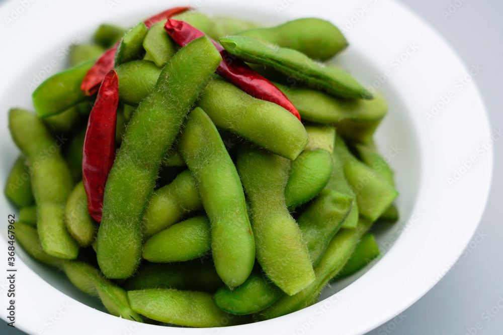 A traditional Chinese delicacy in solid color, boiled soybeans in brine. Chinese traditional food boiled soybean. A traditional Chinese delicacy in solid color, boiled soybeans in brine. Chinese traditional food boiled soybean.