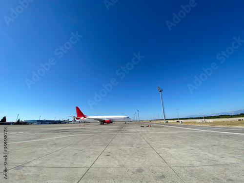 An airplane parked on the apron at Antalya airport. photo