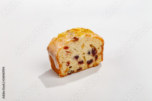 piece of cupcake with raisins and nuts on a white background