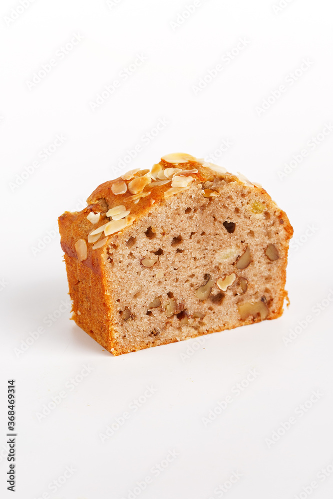 piece of cupcake with raisins and nuts on a white background piece of cupcake with raisins and nuts on a white background