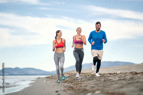 Enjoying By The Sea  Jogging and  Exercise. Healthy  lifestyle.People running on beach.