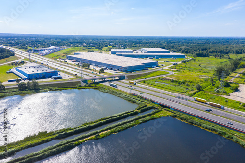 Aerial Shot of Industrial Loading Area where Many Trucks Are Unloading Merchandise.