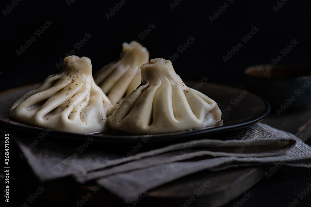 Traditional georgian khinkali dish on stone background Traditional georgian khinkali dish on stone background