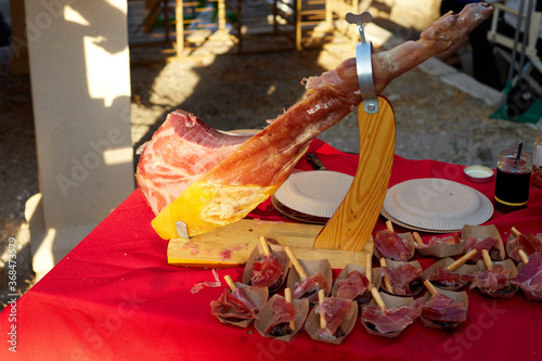 Jamon on the table outside, on red cloth